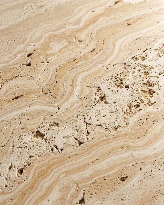 Warm travertine surface used across the brand's materials